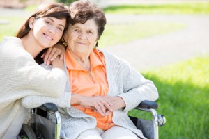 Frau pflegt Mutter im Rollstuhl liest ihr Buch vor midlife coaching